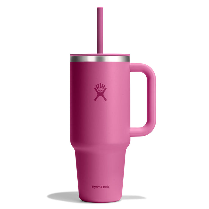 A 40 oz Hydro Flask travel tumbler in tall pink features a handle and straw, double-wall vacuum insulation, a matte finish, and the iconic logo near the top.