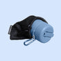 A blue portable water bottle with a screw-on lid, partially enclosed in a black mesh pouch with carabiner. The word HUSKY appears on the bottle and tag. Ideal for pairing with your TUSHY Travel Portable Bidet.