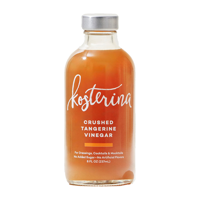 An 8 fl oz clear glass bottle of Kosterina Crushed Tangerine Vinegar, filled with orange citrus vinegar and sealed with a metal cap, perfect for dressing, cocktails, or mocktails—no added sugar.