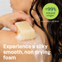 A person with wet hair uses a foamy ATTITUDE super leaves Body Soap Bar on their shoulder. Text on the image: “+99% natural origin¹,” “¹According to ISO 16128,” and “Silky smooth, non-drying foam made with natural ingredients.”.