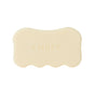 The Body Serum Bar Set by Ember Wellness features a beige, scallop-edged soap bar embossed with "EMBER," designed for deep hydration, displayed against a white background.