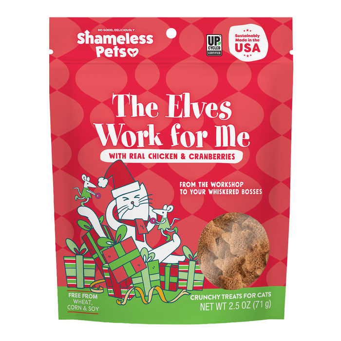 Shameless Pets Crunchy Cat Treats - The Elves Work for Me comes in a red bag featuring a festive cat with presents, a window displaying the treats inside, and highlights such as real chicken, upcycled ingredients, no wheat, corn or soy, and made in the USA.