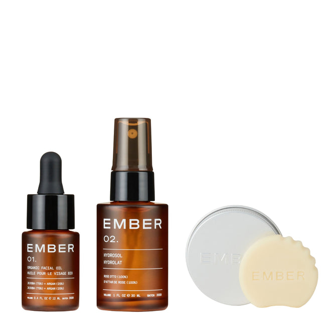 The Face Starter Set by Ember Wellness includes three products—Facial Oil, Hydrosol, and the Serum Bar—in amber and silver packaging.