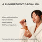 A woman in a white robe applies The Face Starter Set by Ember Wellness, a 2-ingredient facial oil suitable for all skin types, even sensitive or reactive skin, promoting healthy and radiant skin.