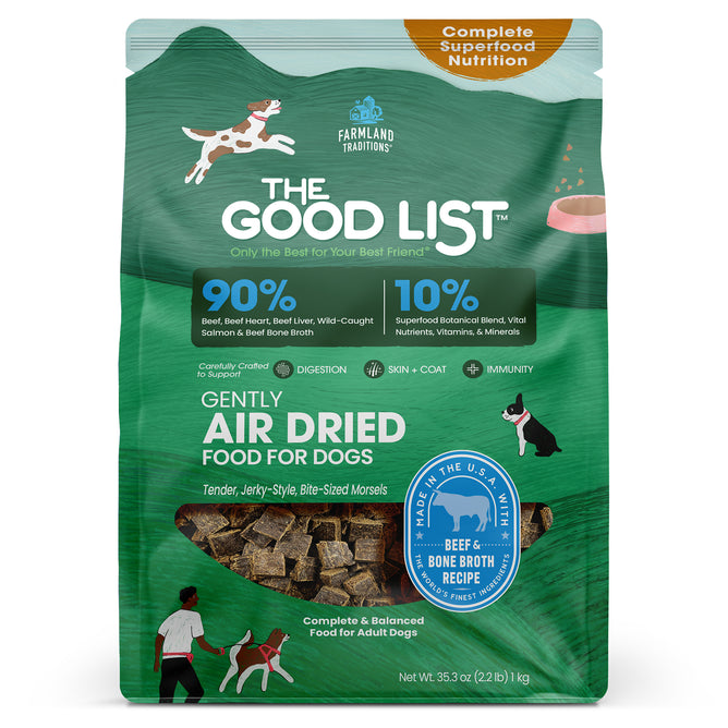 A green bag of The Good List by Farmland Traditions Beef & Bone Broth Recipe dog food topper and mixer displays playful dogs, product pieces, and highlights 90% animal protein and 10% superfoods for adult dogs seeking premium nutrition.
