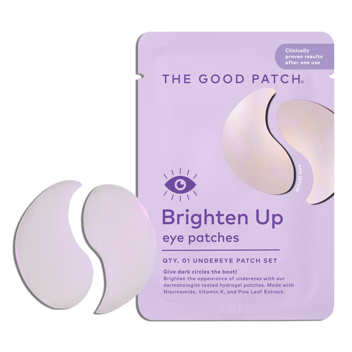 A lavender packet labeled The Good Patch Brighten-Up Hydrogel Undereye Patch is shown with two crescent patches, claiming to boost under-eye brightness and reduce dark circles with vitamin C and botanical extracts.