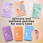 Six colorful The Good Patch wellness patch packages are arranged in a semicircle above the text, with a hand below showing Un-Wrinkle Microdart Patches from The Good Patch applied to help reduce fine lines and wrinkles.