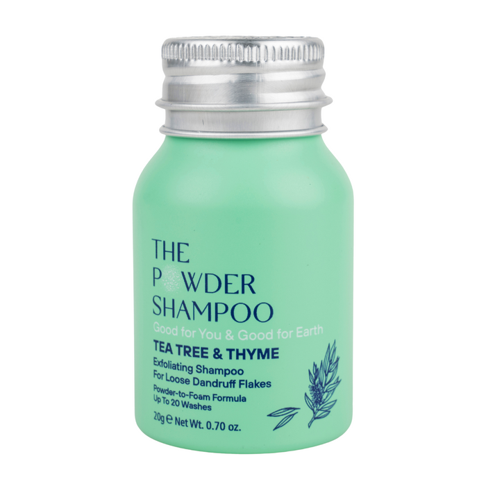 A small mint green bottle from The Powder Shampoo labeled Exfoliating Shampoo, with a silver cap, this anti-dandruff formula contains tea tree oil and thyme and transforms from powder to foam.