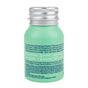 The Powder Shampoo Exfoliating Shampoo comes in a small, mint-green bottle with a silver cap. This water-free, vegan, clean formula with tea tree oil is plastic-free, refillable, and offers a refreshing hair care experience.