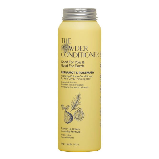 A yellow bottle of The Powder Shampoo Hydrating Volume Conditioner, formulated for fine and thinning hair with bergamot and rosemary, featuring illustrations of bergamot fruit and rosemary on the label.
