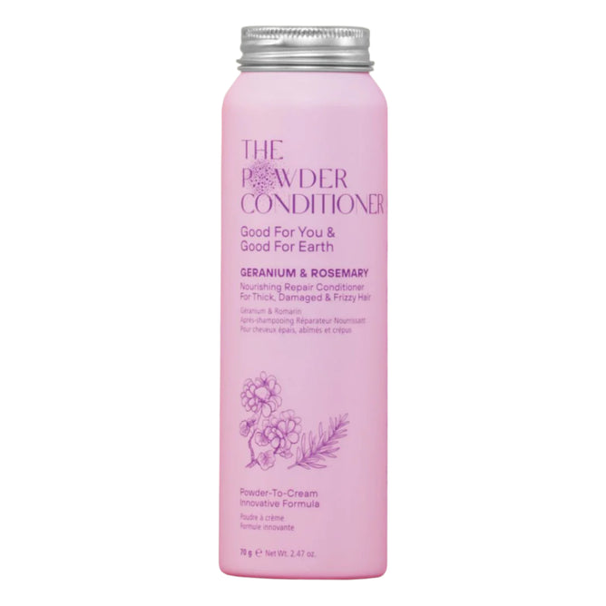 A tall, cylindrical pink bottle from The Powder Shampoo labeled Nourishing Repair Conditioner, featuring geranium and rosemary illustrations. It contains natural oils for thick, damaged, and frizzy hair.
