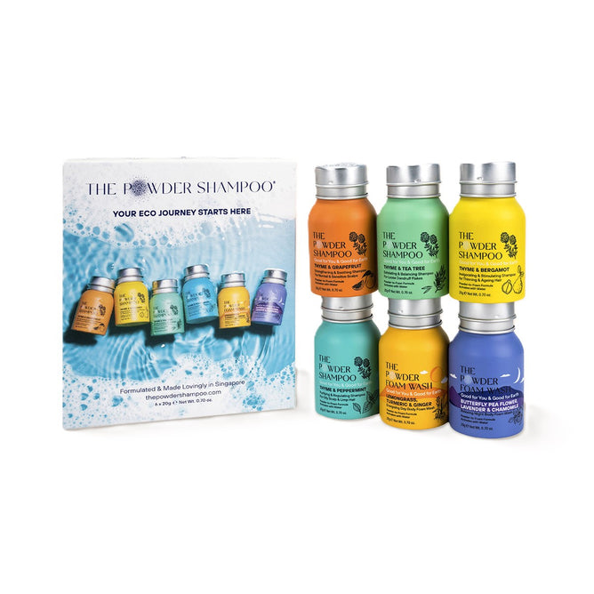 A display showcases the Powder Discovery Set by The Powder Shampoo—seven colorful bottles arranged next to a card with images and info on starting sustainable, eco-friendly hair care routines.