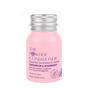 A small pink bottle of The Powder Shampoo’s Nourishing Repair Conditioner with geranium, rosemary, and natural oils for frizzy and damaged hair, featuring a silver cap and purple text on the front.