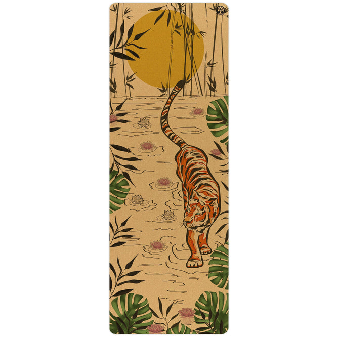 The Tiger Lotus Aura Cork Yoga Mat by Yoloha Yoga showcases a sustainable design with a tiger walking on sand, surrounded by green leaves, pink flowers, and tall bamboo beneath a large yellow sun.