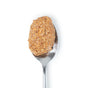 A spoonful of Big Spoon Roasters Toasted Coconut Almond Butter, crafted with heirloom Mission almonds, sits on a metal spoon against a white background.