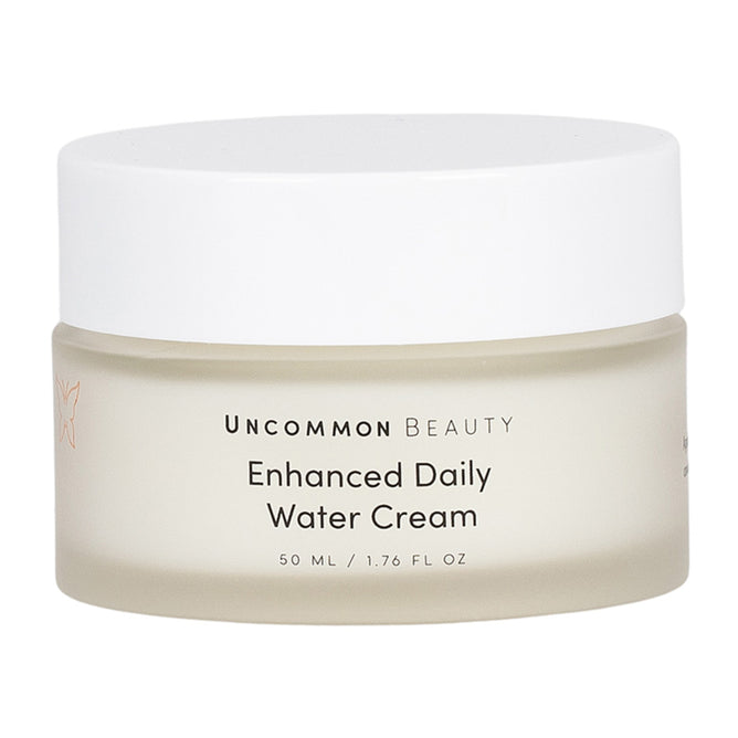 Uncommon Beauty Enhanced Daily Water Cream comes in a 50 ml frosted jar with a white lid. This lightweight moisturizer hydrates and supports your skin barrier for a radiant complexion.
