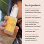 A hand holds a bottle of Uncommon Beauty Enhanced Pineapple Peptide Nectar. Beside it, text highlights key ingredients—pineapple, papaya, lemon, coconut, and apricot extracts—plus vitamin C and their skincare benefits.