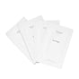 Four white single-use Uncommon Beauty Eye Masks packets are fanned out on a white background, offering a refreshed look and youthful glow.