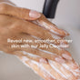 Close-up of hands gently massaging Uncommon Beautys Mini Jelly Cleanser onto skin. The image highlights soft, smooth nails and a soothing cleansing motion. Fragrance-free formula ideal for sensitive skin, leaving it calm and refreshed.