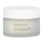 A frosted glass jar with a white lid, labeled “Koji Pads” by Uncommon Beauty, displays usage instructions and warnings; these skincare pads are formulated as a skin perfector to brighten your complexion.