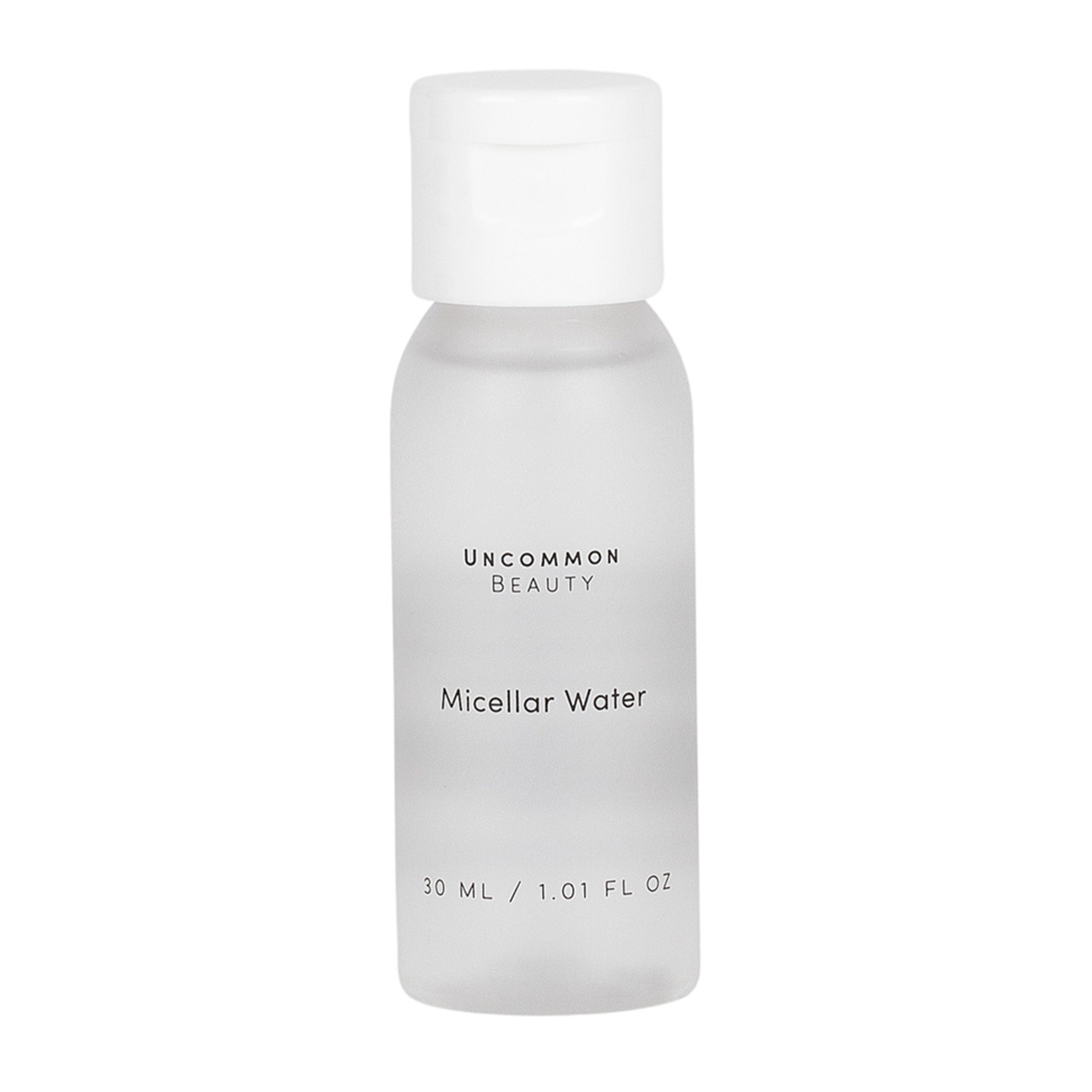 A small, clear plastic bottle with a white cap labeled Uncommon Beauty Mini Micellar Water, 30 ml / 1.01 fl oz on the front; this gentle cleanser from Uncommon Beauty also works as an effective makeup remover.