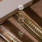 A close-up of Hard Feelings Eau de Parfum by Uncommon Beauty, showing EWG Verified, Leaping Bunny Certified, and Vegan icons. The scent captivates with enticing sandalwood notes.
