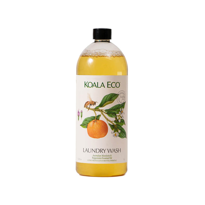 A clear bottle of Koala Eco Laundry Wash - Mandarin & Peppermint with yellow liquid, a black cap, and a label showing an orange and green leaves.