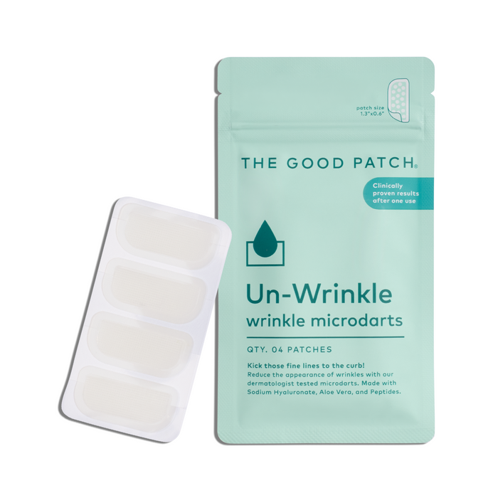 A teal pouch labeled The Good Patch Un-Wrinkle Microdart Patches sits beside a blister pack of four clear rectangular patches that help reduce fine lines and wrinkles for smoother-looking skin.