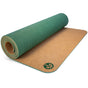A partially rolled green Unity Pro Cork Yoga Mat by Yoloha Yoga, featuring a sustainable cork underside and a circular leaf-design logo in one corner.