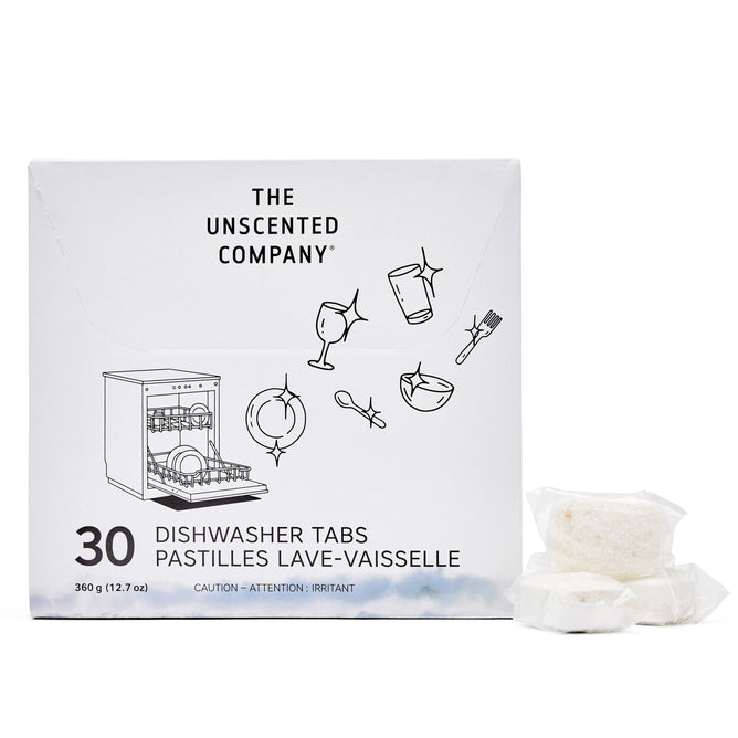 A box of The Unscented Company Dishwasher Tabs, with simple dish-themed line art, sits beside two white vegan dishwasher tabs wrapped in plastic.