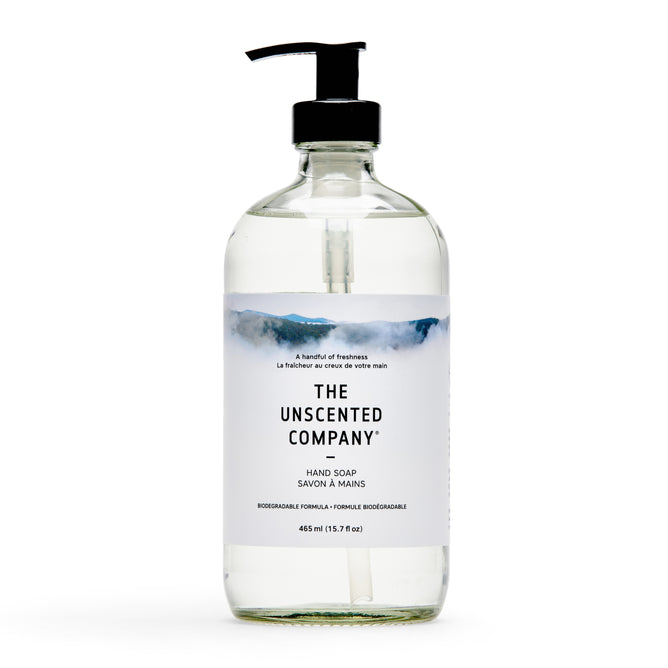 A clear 465 ml (15.7 fl oz) pump bottle of The Unscented Company Hand Soap, vegan and biodegradable, with a minimalist label showing a misty mountain design. This unscented liquid soap is gentle and eco-friendly.