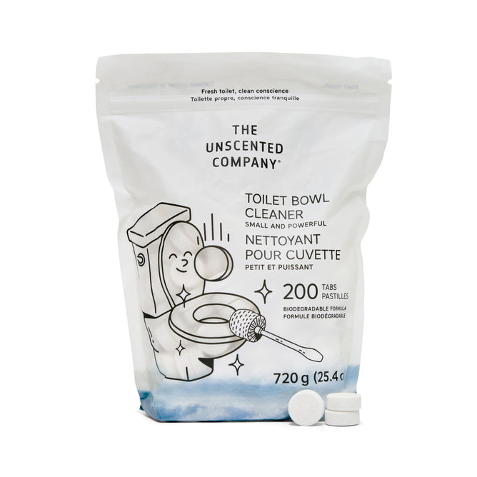A white resealable bag of The Unscented Company Toilet Bowl Cleaning Tabs - Unscented is shown, featuring an illustrated toilet and hand. The 200 biodegradable tablets (720g) offer sustainable hygiene and drain care. Two round tabs are displayed in front.