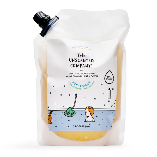 The Unscented Company Kids Shiny Shampoo Refill Bag, 1L, features a white label with a cartoon child in a bathtub and blue accents. Made with natural ingredients, the pouch has a black spout for easy pouring.