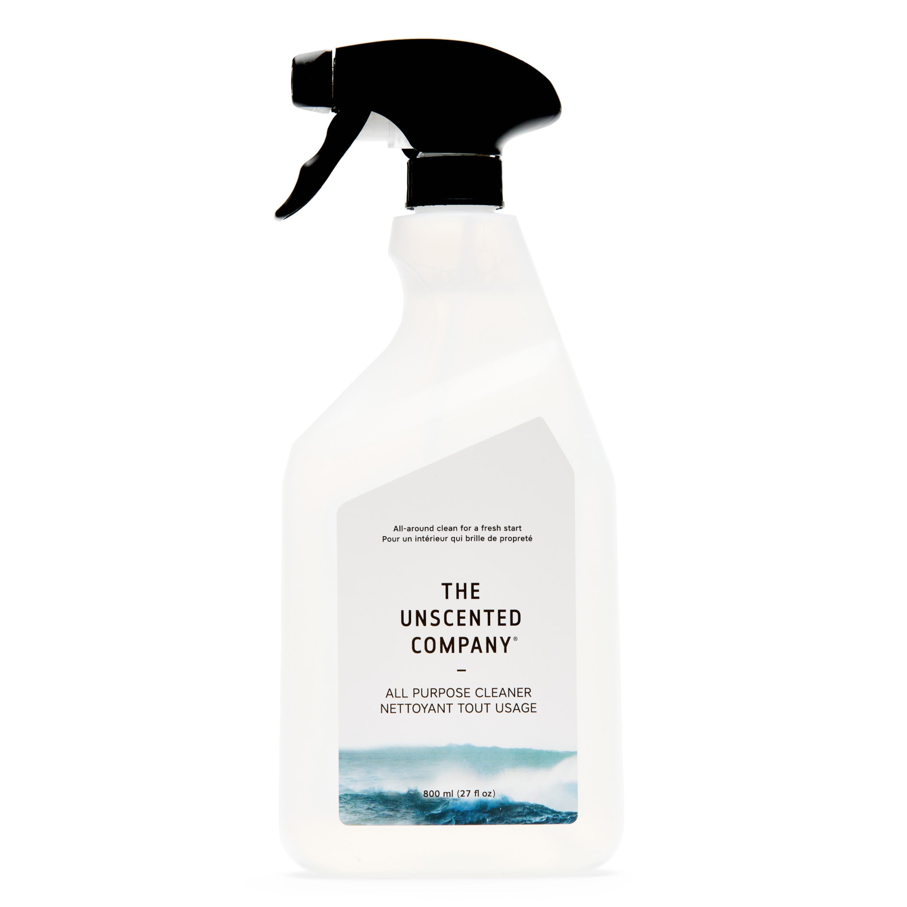 A white spray bottle of The Unscented Company All Purpose Cleaner - Unscented, with a black nozzle, minimalist label featuring blue wave graphics, and made using vegan ingredients.