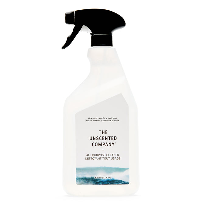 A white spray bottle of The Unscented Company All Purpose Cleaner - Unscented, with a black nozzle, minimalist label featuring blue wave graphics, and made using vegan ingredients.