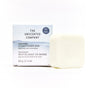 A plastic-free, unscented Conditioner Bar by The Unscented Company sits in front of its white and light blue box labeled "Nourishing Conditioner Bar with Shea and Cocoa Butter, 65g (2.3oz).