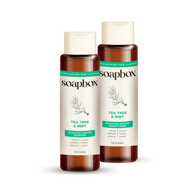 The Soapbox Tea Tree Clean & Purify Shampoo and Conditioner Set features tea tree oil for scalp balance, has vegan ingredients, and comes in bottles with brown caps and green accents.
