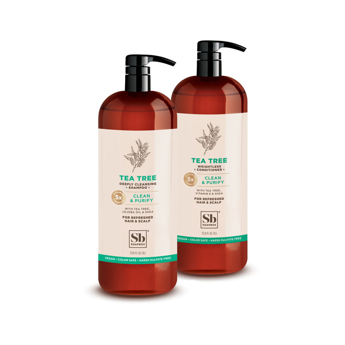 Two brown pump bottles labeled Tea Tree Shampoo & Conditioner 1 Liter Luxe from Soapbox are shown on a white background. The labels highlight their deep cleansing, vegan, color safe, and hard sulfate free formula for hair and scalp.