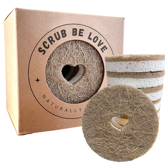 Round Heart Dish Sponge Pack by Scrub Be Love features eco-friendly round coconut coir sponges, each with a heart-shaped cutout, stacked beside a brown box showcasing the same heart cutout and promoting zero-waste cleaning.