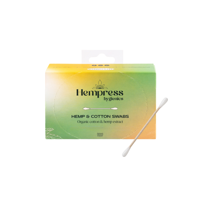 A box of Hempress Hygienics Hemp Swabs in green and yellow gradient packaging, labeled “Organic cotton & hemp extract—perfect for sensitive skin,” with one organic swab displayed in front.