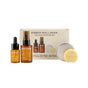 The Ember Wellness The Face Starter Set includes a facial oil dropper bottle, hydrosol spray, mini serum bar in a round tin with soap, all packaged in a beige box.