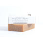 A brown Matcha & Argan Bar by Little Seed Farm, partially wrapped in white packaging, features matcha and argan oil for anti-aging benefits with anti-inflammatory and antioxidant natural ingredients on a white background.