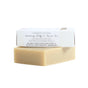 The Orange Vetiver Bar by Little Seed Farm is a beige cleansing body & facial soap with organic essential oils, hydrating properties, and healing for dry skin—all without artificial or synthetic ingredients. Comes partially wrapped in white packaging.