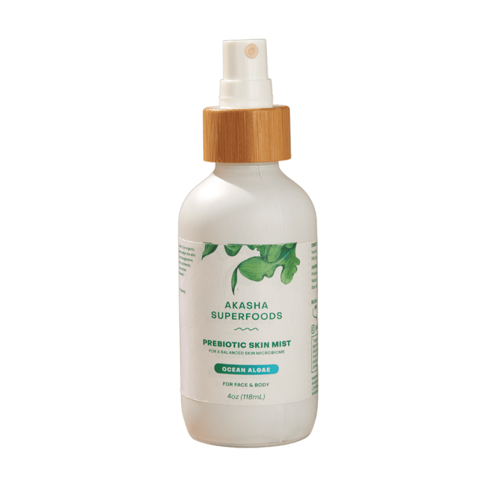 Akasha Superfoods Prebiotic Skin Mist, Ocean Algae for Face & Body, 4oz (118mL), comes with a wooden cap and spray nozzle. The label, featuring green leaf graphics, promotes radiant skin and soothes acne.