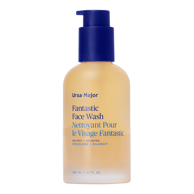 A clear 120 ml (4 fl oz) bottle of Ursa Major Fantastic Face Wash with a blue pump and blue/yellow label, offering gentle exfoliation for daily cleansing and smooth skin.
