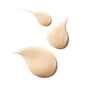 Three beige, teardrop-shaped drops of liquid foundation, ideal for layering over Ursa Major’s Fortifying Gel Moisturizer, displayed on a white background.