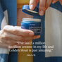 A person holding an open jar of Ursa Major Golden Hour Recovery Cream, accompanied by a quote below praising the deep hydration provided by this Ursa Major face cream.
