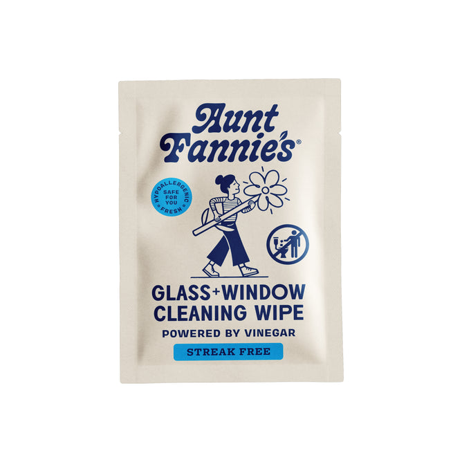 Aunt Fannie's Glass + Window Cleaning Wipe - Sample packet features a blue illustration of a woman cleaning, highlights streak-free results with vinegar and clean ingredients, and is labeled safe for people and pets.