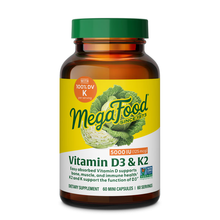 A brown MegaFood Vitamin D3 5000 IU & K2 bottle with a yellow cap, labeled 5000 IU (125 mcg) per serving. Supports bone, muscle, and immune health. Contains 60 mini capsules.