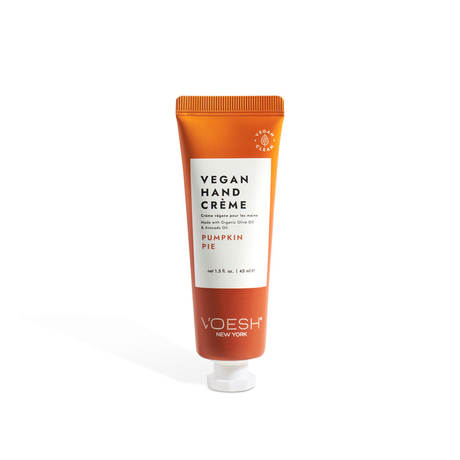 A 1.5 oz tube of VOESH Pumpkin Pie Vegan Hand Crème with pumpkin extract and a white label stands upright against a white background, featuring an orange tube and a white cap.